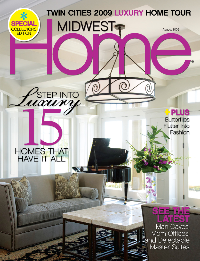 Midwest Home August 2009 Cover showing a white living room with a black grand piano in the background, a hanging plant with purple flowers, a gray sofa, dark area rug and a marble and metal cocktail table.